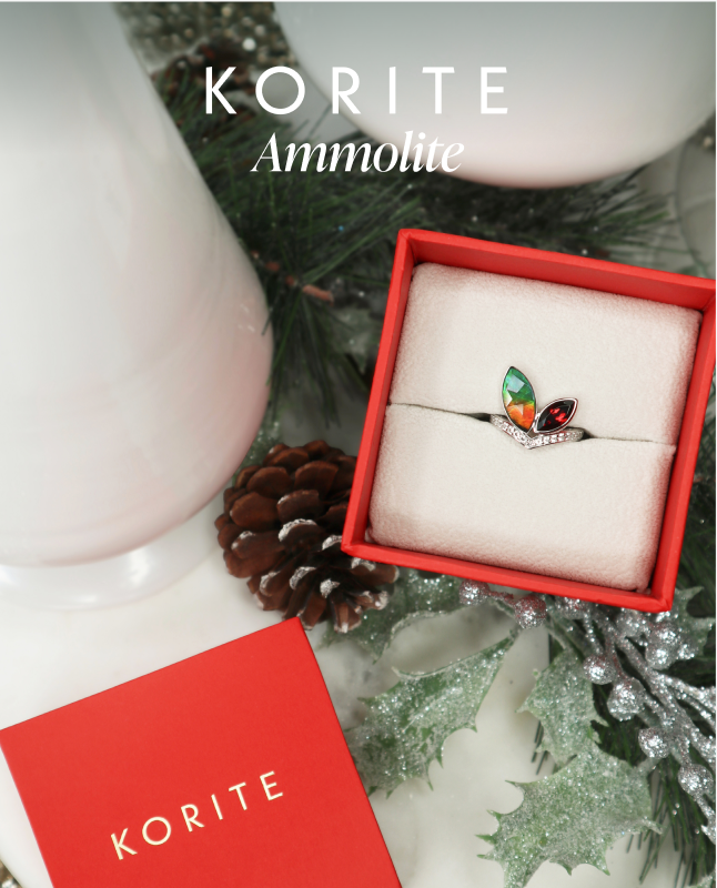 Happy Holidays from KORITE Ammolite, featuring a silver ring with Ammolite AA grade stone, white topaz and garnet accent stones