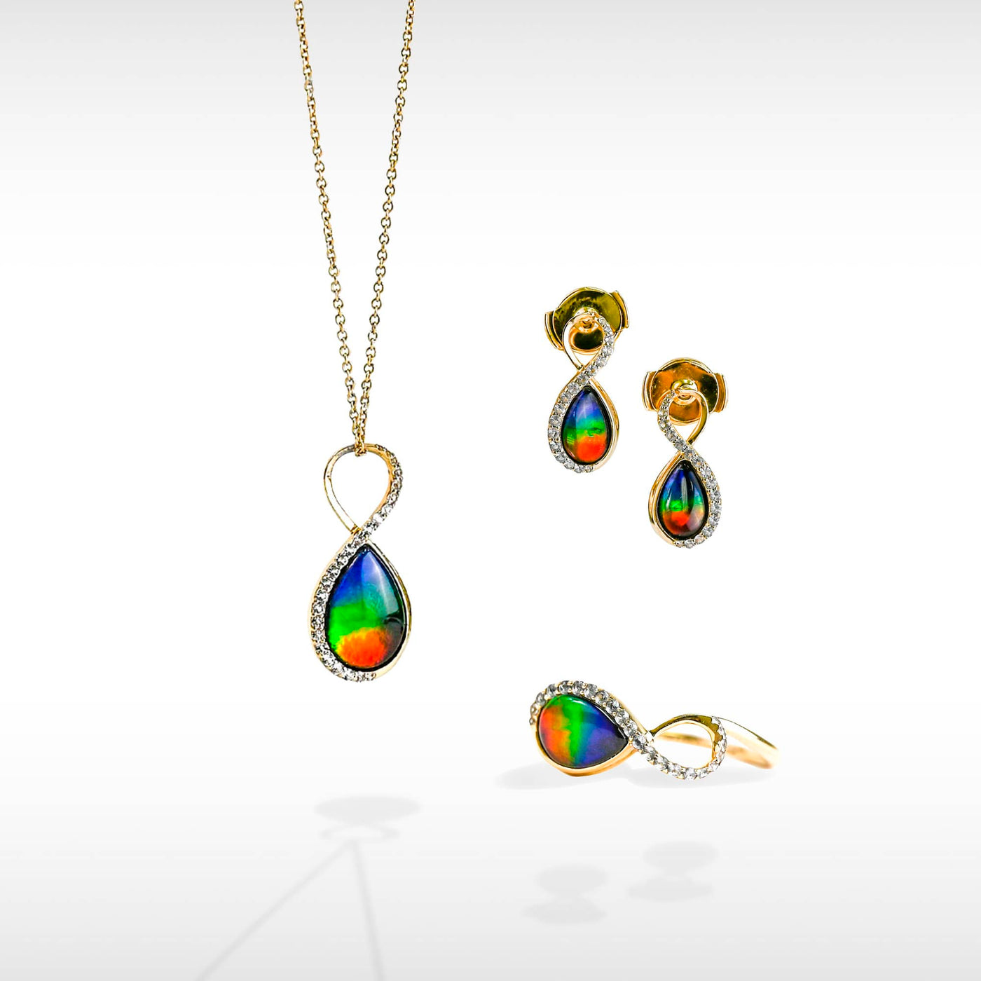 Infinity ammolite pendant, earring and ring set with white diamonds in 14K gold