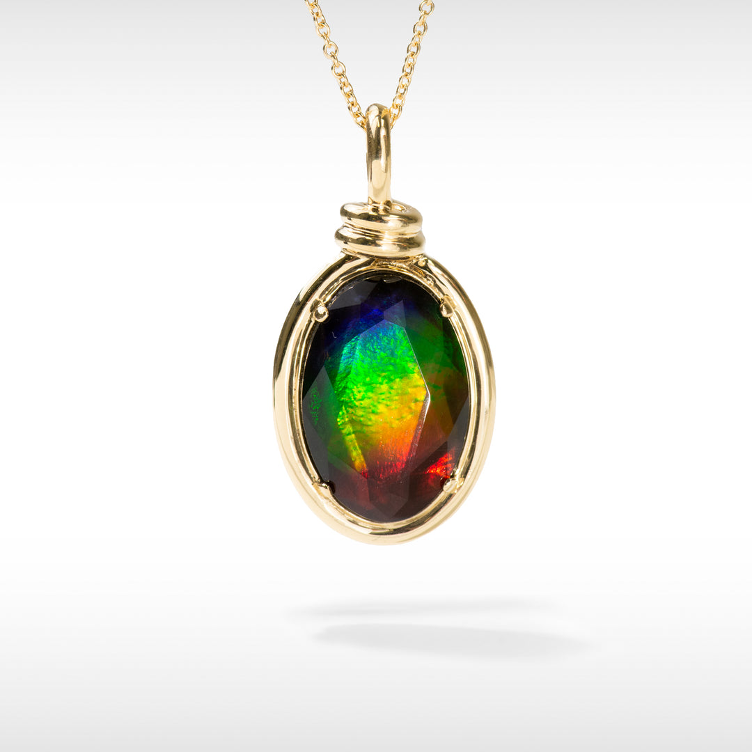 An 18K gold pendant featuring a colorful Ammolite stone with a rope design element, displayed on a gold chain.